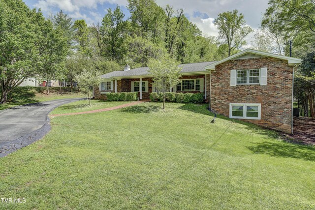 103 Dogwood Ln, Johnson City, TN 37604 - view of front of property featuring brick siding, driveway, a chimney, and a front lawn