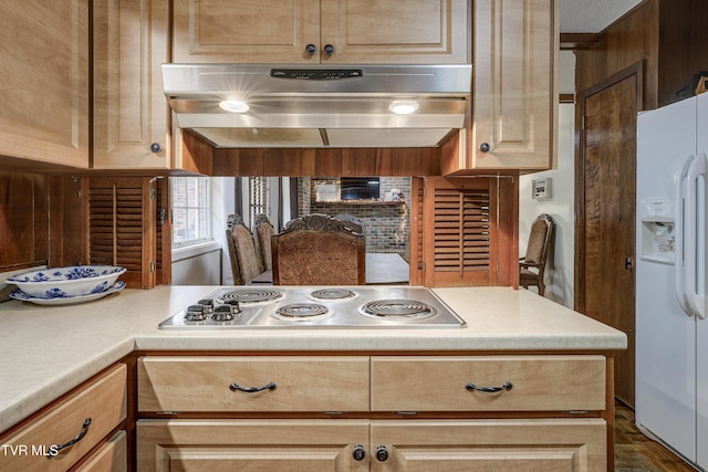 103 Dogwood Ln, Johnson City, TN 37604 - kitchen with stainless steel stovetop, light brown cabinetry, under cabinet range hood, light countertops, and white fridge with ice dispenser