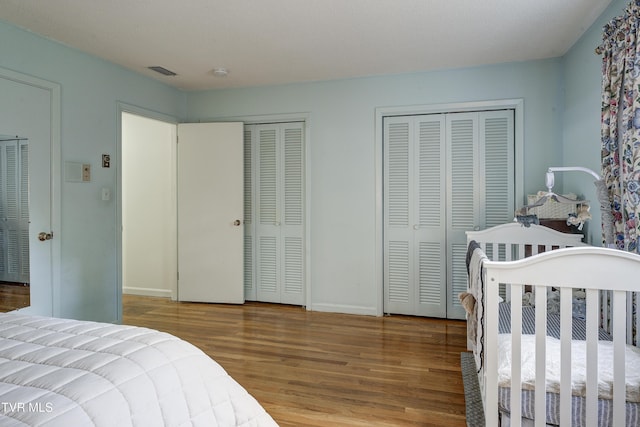103 Dogwood Ln, Johnson City, TN 37604 - bedroom with visible vents, baseboards, wood finished floors, and two closets