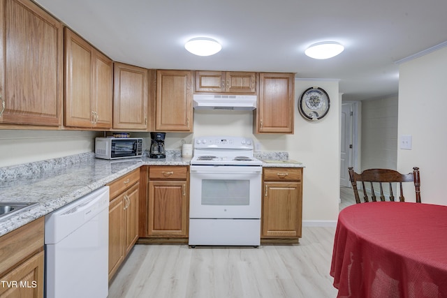 103 Dogwood Ln, Johnson City, TN 37604 - kitchen with under cabinet range hood, light wood-style flooring, white appliances, and light stone counters