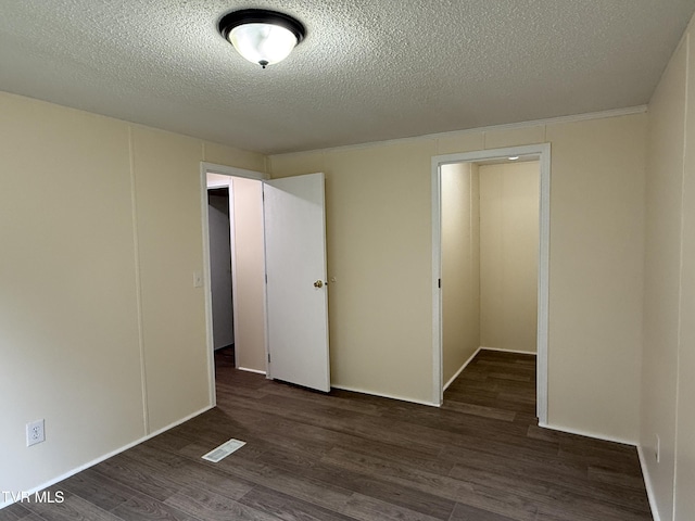 136 Gentry Mountain Rd, Erwin, TN 37650 - unfurnished bedroom with a textured ceiling, visible vents, and wood finished floors