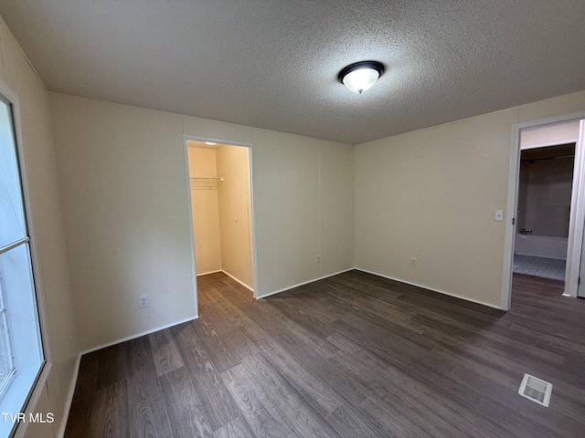 136 Gentry Mountain Rd, Erwin, TN 37650 - unfurnished room featuring visible vents, a textured ceiling, dark wood finished floors, and baseboards