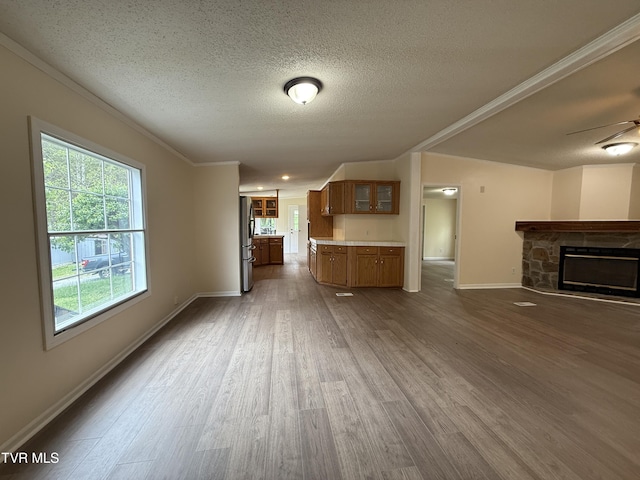 136 Gentry Mountain Rd, Erwin, TN 37650 - unfurnished living room with baseboards, a stone fireplace, a textured ceiling, a ceiling fan, and dark wood finished floors