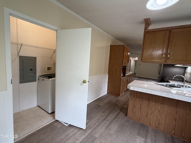 136 Gentry Mountain Rd, Erwin, TN 37650 - kitchen with washer / clothes dryer, tile counters, brown cabinets, electric panel, and a sink