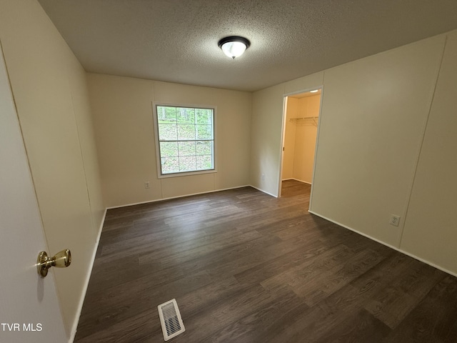 136 Gentry Mountain Rd, Erwin, TN 37650 - spare room featuring baseboards, a textured ceiling, visible vents, and dark wood finished floors