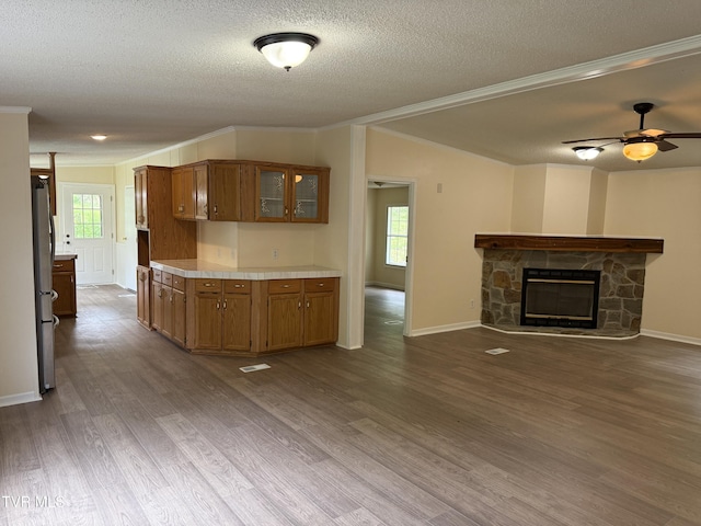 136 Gentry Mountain Rd, Erwin, TN 37650 - kitchen with brown cabinetry, a textured ceiling, crown molding, light countertops, and freestanding refrigerator