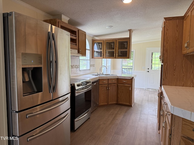 136 Gentry Mountain Rd, Erwin, TN 37650 - kitchen featuring brown cabinetry, a sink, appliances with stainless steel finishes, and wood finished floors
