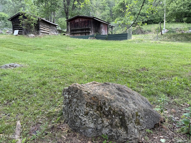 136 Gentry Mountain Rd, Erwin, TN 37650 - view of yard with a storage unit, an outdoor structure, and a wooded view