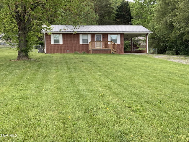 ranch-style home with brick siding, a front yard, and metal roof