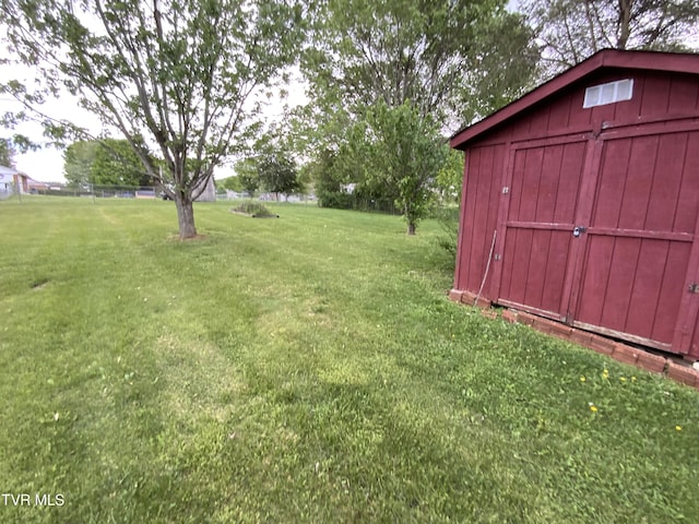 view of yard featuring an outbuilding and a shed