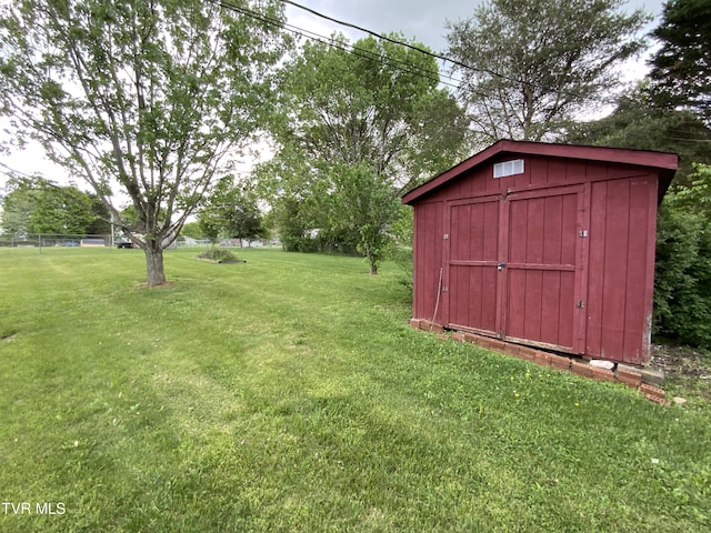 view of yard featuring a storage unit and an outbuilding