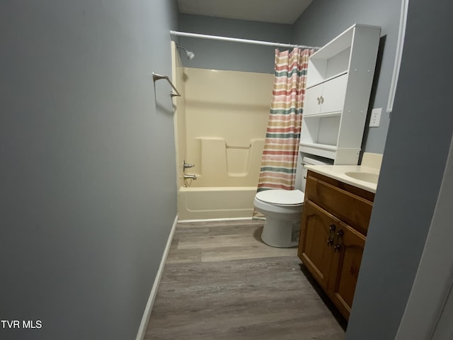 bathroom featuring toilet, vanity, shower / tub combo, and wood finished floors