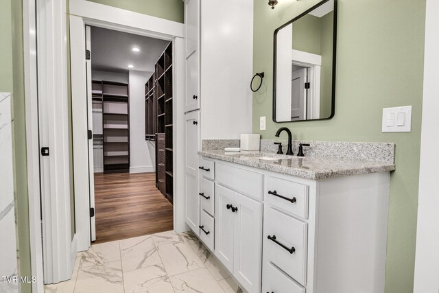 14737 Washington Way, Bristol, VA 24202 - bathroom with vanity, marble finish floor, baseboards, a walk in closet, and recessed lighting