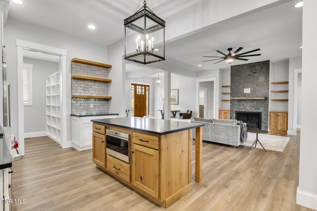 14737 Washington Way, Bristol, VA 24202 - kitchen featuring open shelves, dark countertops, light wood finished floors, ceiling fan with notable chandelier, and baseboards