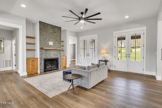 14737 Washington Way, Bristol, VA 24202 - living room featuring french doors, baseboards, a tiled fireplace, and visible vents