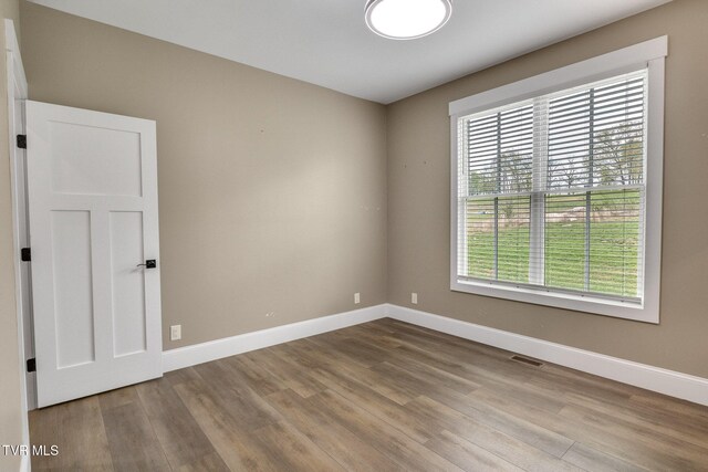 14737 Washington Way, Bristol, VA 24202 - empty room with baseboards, wood finished floors, and a wealth of natural light
