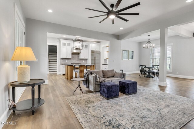 14737 Washington Way, Bristol, VA 24202 - living room with light wood-style floors, baseboards, ceiling fan with notable chandelier, and recessed lighting