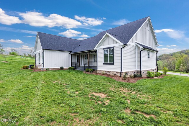 14737 Washington Way, Bristol, VA 24202 - view of front of house featuring roof with shingles, a front lawn, board and batten siding, a porch, and crawl space