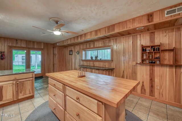 1010 Heaton Creek Rd, Roan Mountain, TN 37687 - kitchen featuring wood walls, wood counters, visible vents, and a wealth of natural light