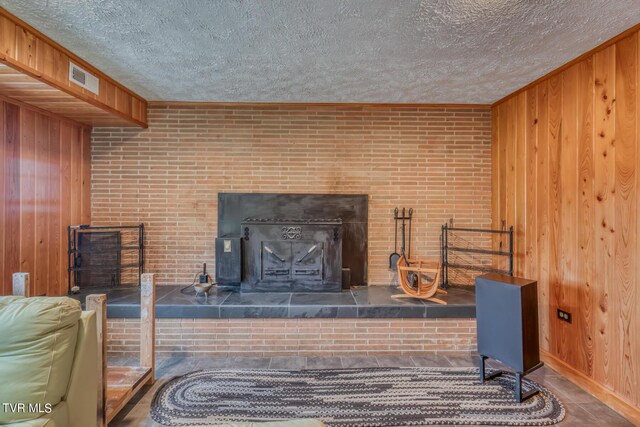 1010 Heaton Creek Rd, Roan Mountain, TN 37687 - living area with wooden walls, a textured ceiling, and brick wall