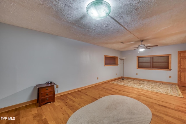 1010 Heaton Creek Rd, Roan Mountain, TN 37687 - living area with baseboards, a ceiling fan, wood finished floors, and a textured ceiling
