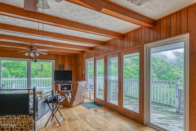 1010 Heaton Creek Rd, Roan Mountain, TN 37687 - sunroom with wooden walls, hardwood / wood-style floors, beamed ceiling, and plenty of natural light