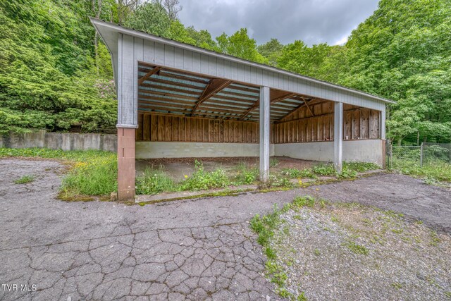 1010 Heaton Creek Rd, Roan Mountain, TN 37687 - view of vehicle parking featuring a detached carport, a forest view, and fence