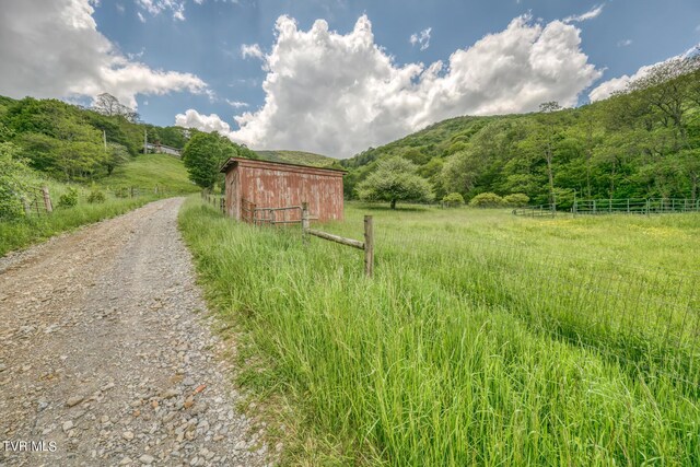 1010 Heaton Creek Rd, Roan Mountain, TN 37687 - exterior space featuring a rural view, driveway, fence, and an outdoor structure