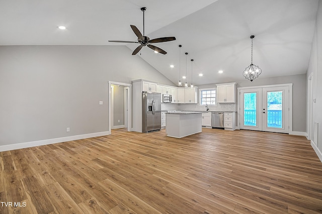 kitchen with recessed lighting, open floor plan, white cabinetry, and stainless steel appliances