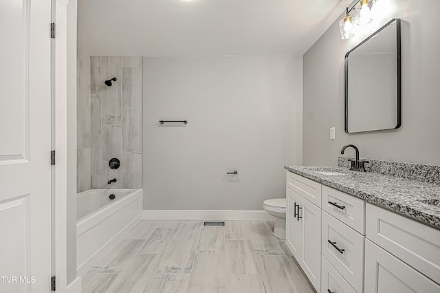 bathroom with visible vents, baseboards, toilet, vanity, and  shower combination