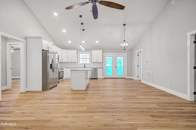 kitchen with light wood-style floors, stainless steel appliances, a ceiling fan, and white cabinets