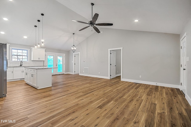 kitchen featuring visible vents, white cabinets, and open floor plan