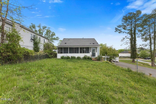 back of property featuring fence and a sunroom