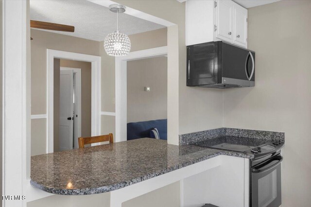800 Pearl St, Bristol, VA 24201 - kitchen featuring white cabinetry, a chandelier, black appliances, decorative light fixtures, and a peninsula