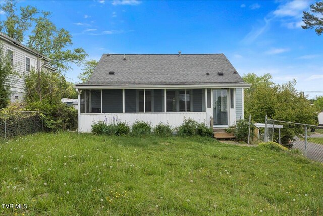 800 Pearl St, Bristol, VA 24201 - back of house with fence, a shingled roof, a sunroom, and a lawn