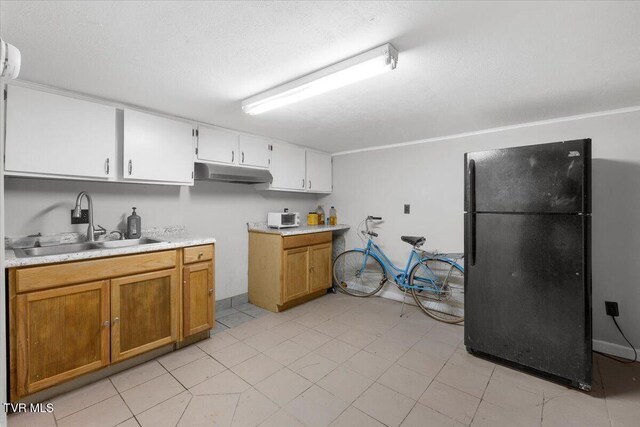 800 Pearl St, Bristol, VA 24201 - kitchen with a sink, under cabinet range hood, brown cabinetry, light countertops, and freestanding refrigerator