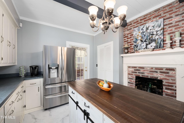 kitchen featuring stainless steel refrigerator with ice dispenser, a chandelier, crown molding, and marble finish floor