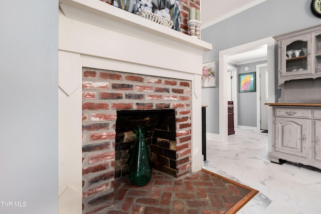 interior details with ornamental molding and a fireplace