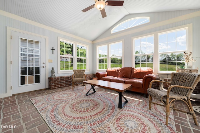 sunroom featuring lofted ceiling and brick floor