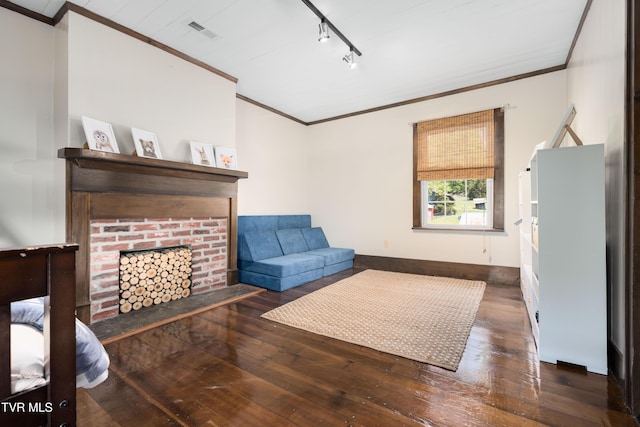 sitting room featuring track lighting, visible vents, hardwood / wood-style flooring, and ornamental molding