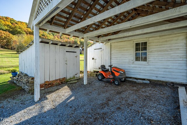 view of patio featuring an outdoor structure and a shed