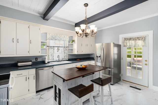 kitchen with open shelves, marble finish floor, appliances with stainless steel finishes, and a sink