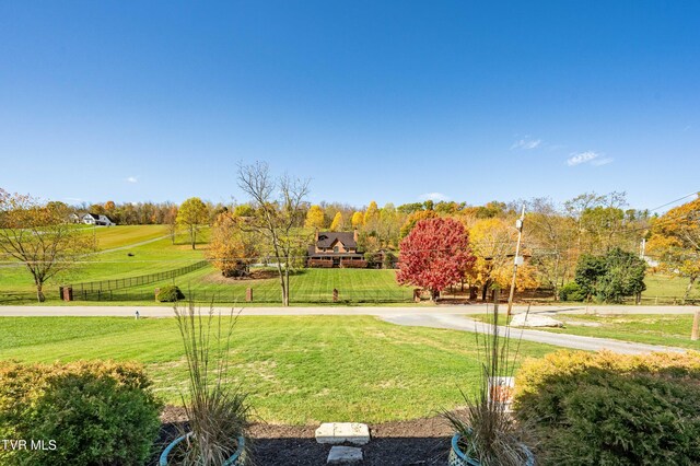 view of property's community with fence and a yard