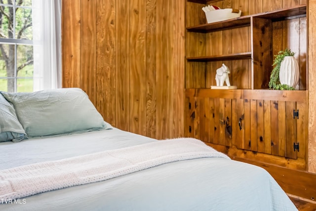 bedroom with wooden walls