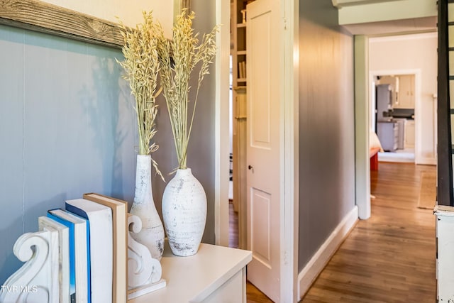 hall with wood finished floors and baseboards