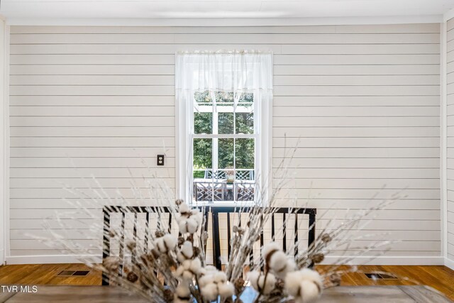 details featuring wooden walls and wood finished floors