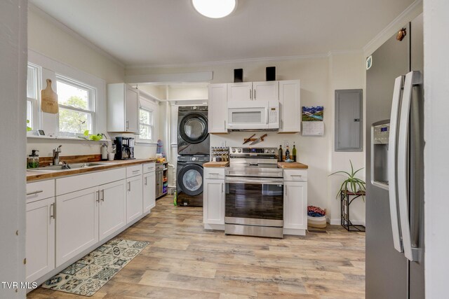 718 Wilson Ave, Johnson City, TN 37604 - kitchen featuring electric panel, wood counters, stacked washing maching and dryer, and stainless steel appliances