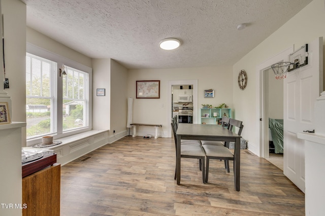 718 Wilson Ave, Johnson City, TN 37604 - dining area with a textured ceiling and wood finished floors