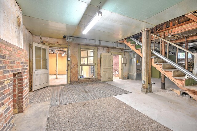 basement with heating unit and stairs