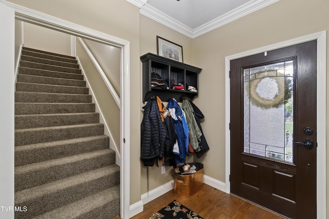 entrance foyer featuring ornamental molding, dark wood-style flooring, stairway, and baseboards